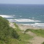 Blick von den bis zu 20 m hohen Wanderdünen auf das unruhige Meer<br />					